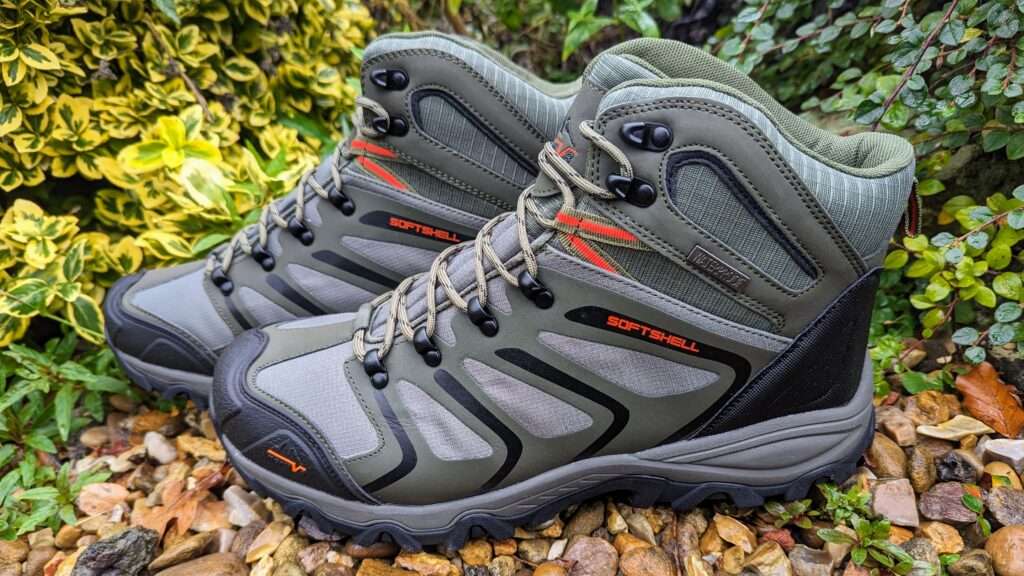 A pair of Nortiv 8 walking boots stanind on gravel