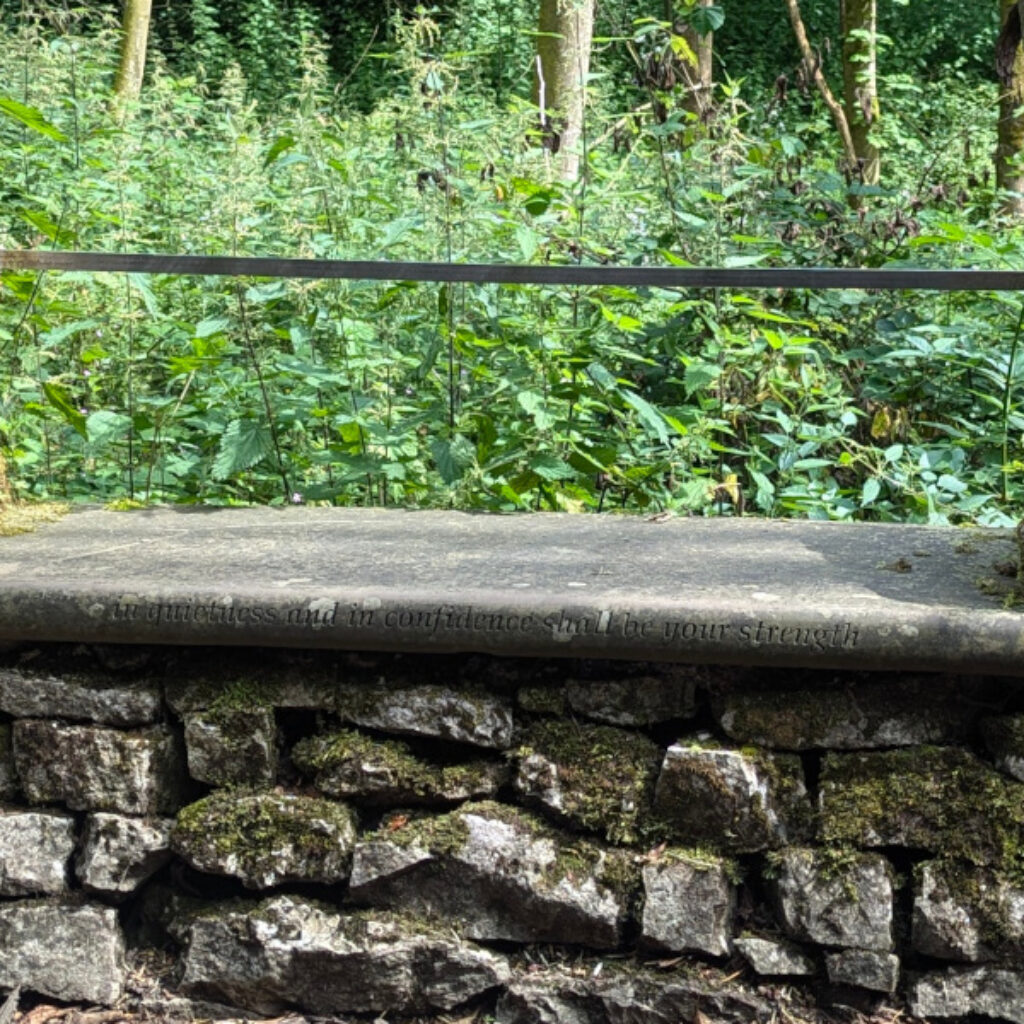 a stone slab seat embedded into a stone wall