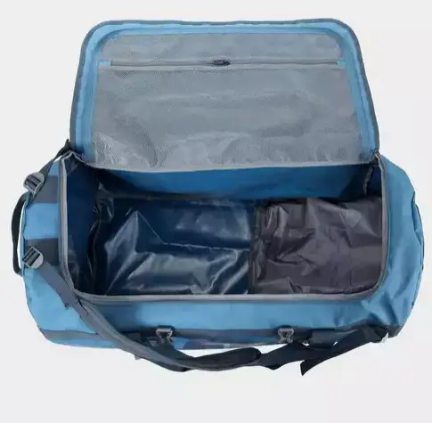 a blue duffel bag style holdall with black trim showing the interior load space currently empty