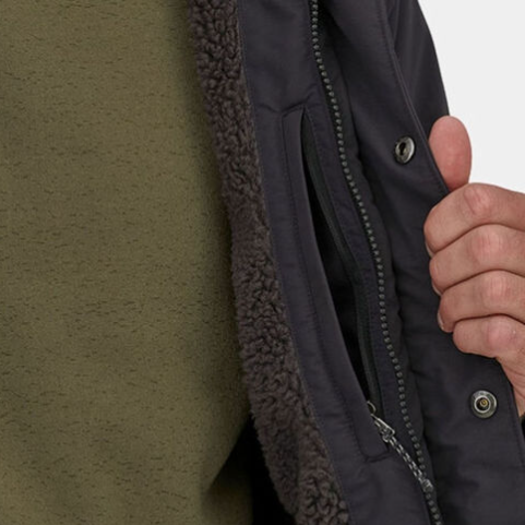 the interior view of the patagonia isthmus parka showing a zip pocket and a fleec lining. 