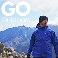 Go Outdoors a man in a blue waterproof jacket hiking in the mountains