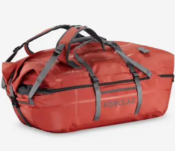 a brick red coloured holdall with carbon grey straps and trim