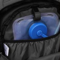 a hydration pack showing in the rear of a rucksack