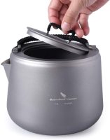 a large titanium camping kettle with a lid with a black handle