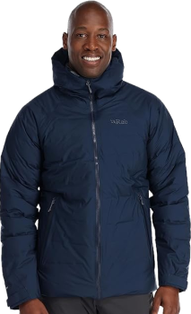 a man in a dark blue waterproof down jacket that has a zip and hood